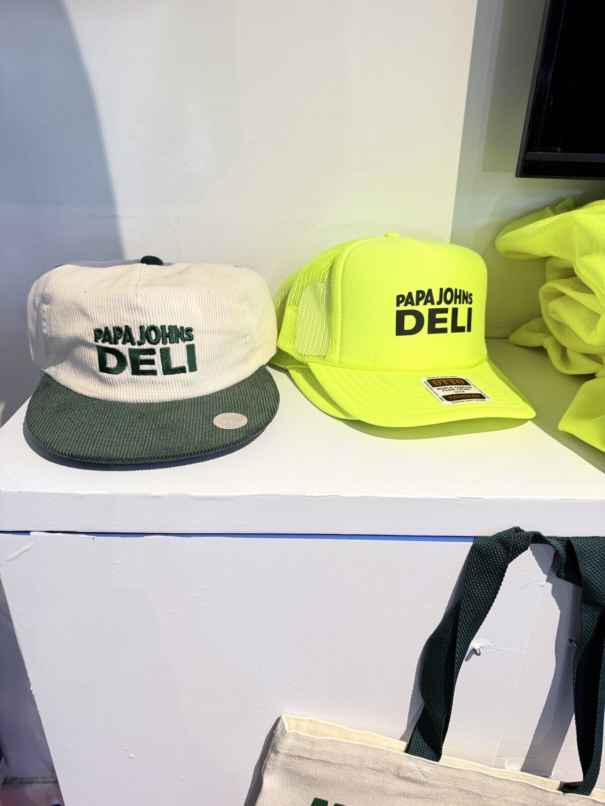Branded merch display of printed shirts arranged at a trade show booth