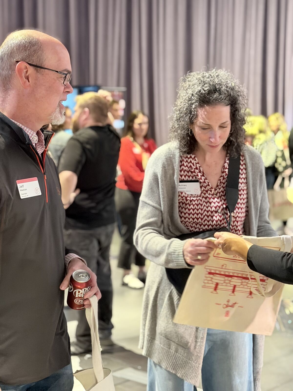 Multiple attendees mingling at a professional conference or corporate event venue