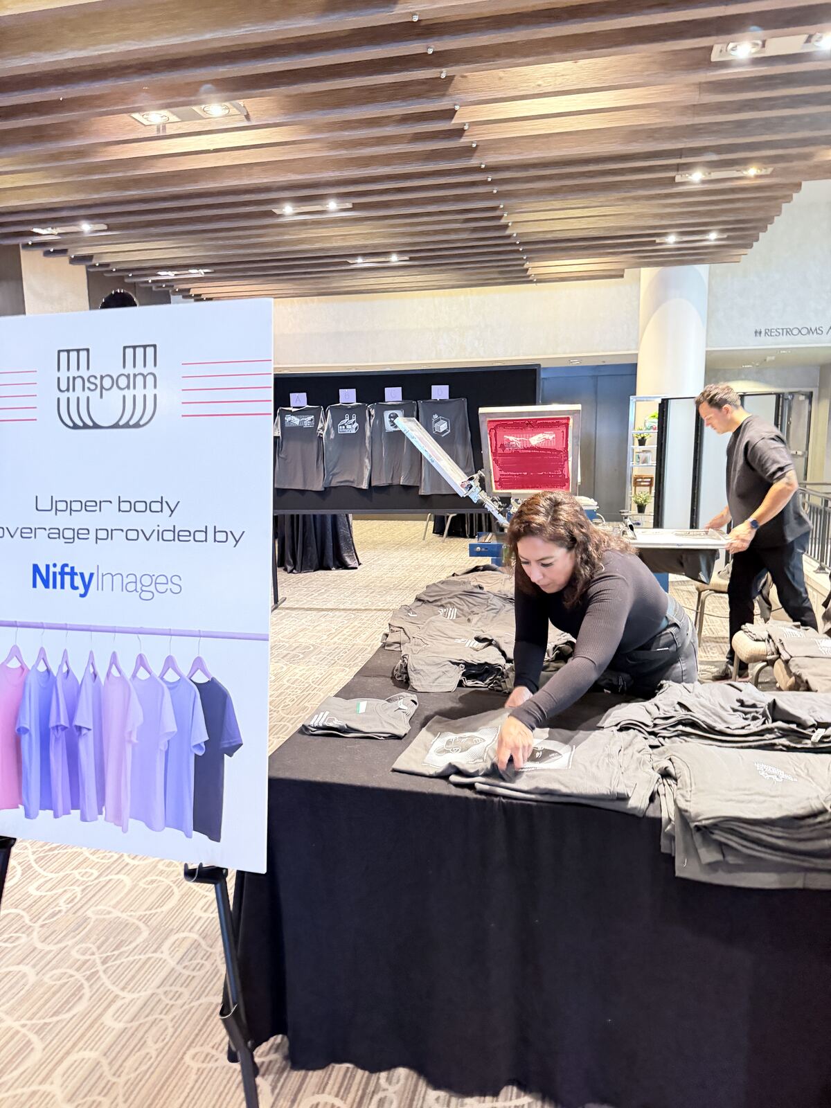 Professional booth setup with merchandise display at a corporate event venue